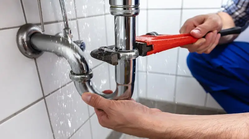 plumber at work in a bathroom, plumbing repair service, assemble and install concept