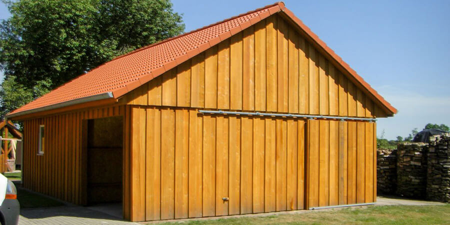 Bauunternehmen Blomberg | Einfamilienhaus aus rotem Klinker mit rotem Dach von der Ingolf Eiben GmbH